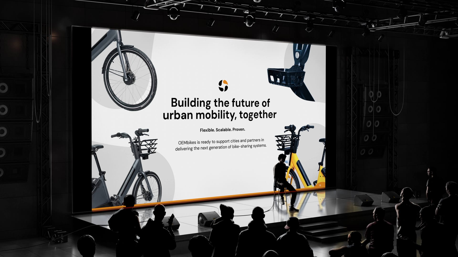 OEMbikes large stage screen presentation showing Building the Future of Urban Mobility Together slide with audience, presentation design by On Poynt Creative