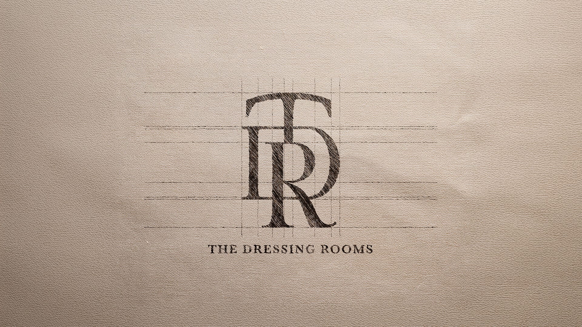 The Dressing Room Bridal monogram emblem stamped onto textured paper, logo design by On Poynt Creative