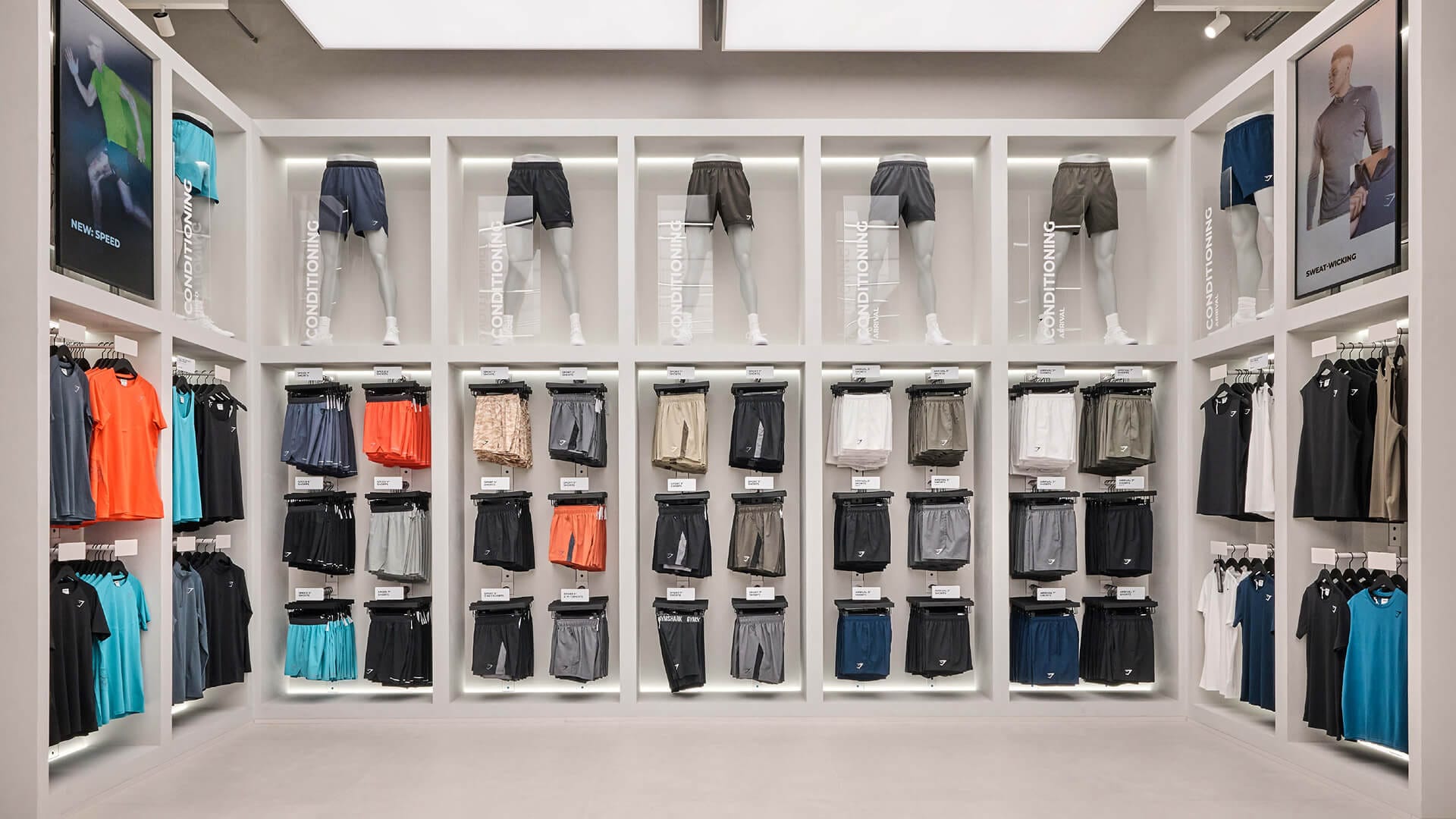 Gymshark Stratford store shorts and conditioning apparel display wall with mannequin legs, retail design by On Poynt Creative