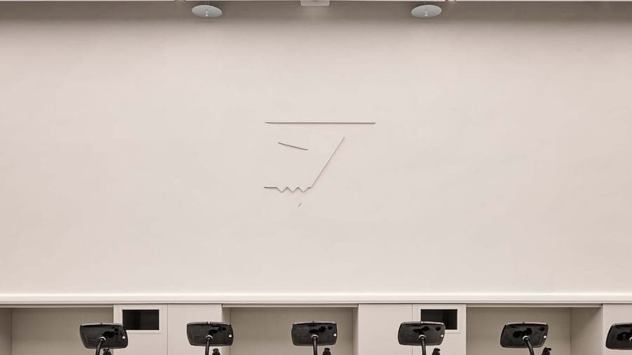 Gymshark Stratford store interior with minimalist line art wall installation above exercise bikes, retail interior design by On Poynt Creative