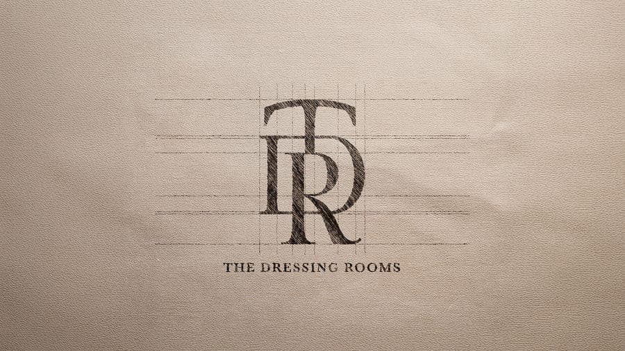 The Dressing Room Bridal monogram emblem stamped onto textured paper, logo design by On Poynt Creative